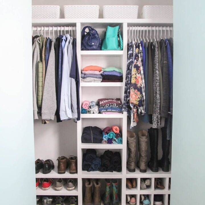 https://www.lovelyetc.com/wp-content/uploads/2021/03/diy-closet-organizer-in-small-closet-filled-with-clothes-and-shoes-720x720.jpg