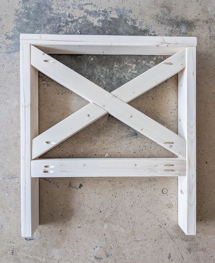 completed side of diy outdoor chair with x detail.