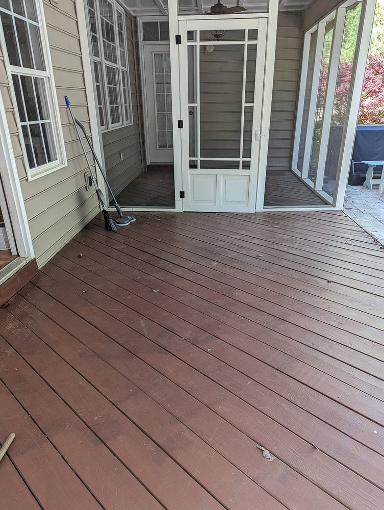 empty back porch leading into screened-in porch.