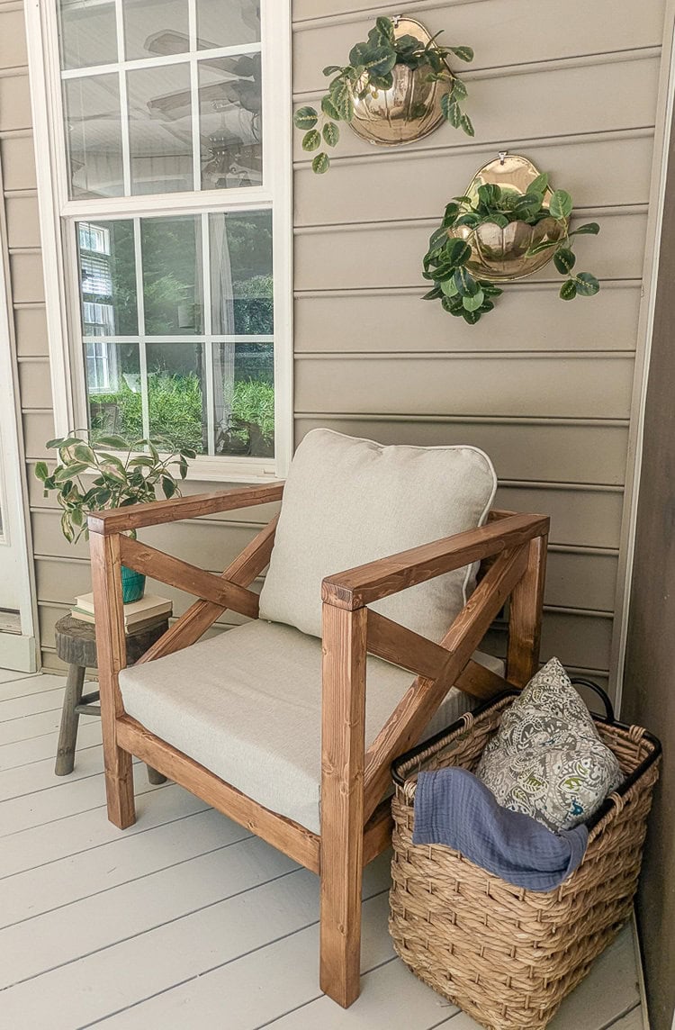 diy wooden outdoor chair and vintage wall planters on porch.