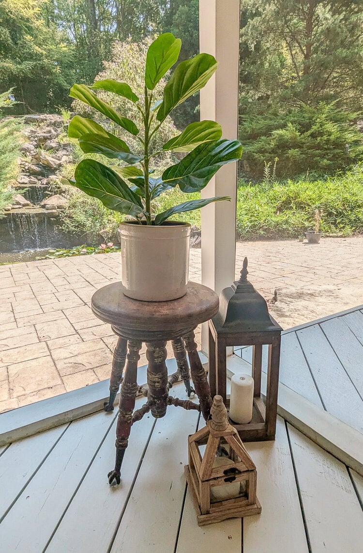 old piano stool, fiddle leaf fig, and lanterns on porch.